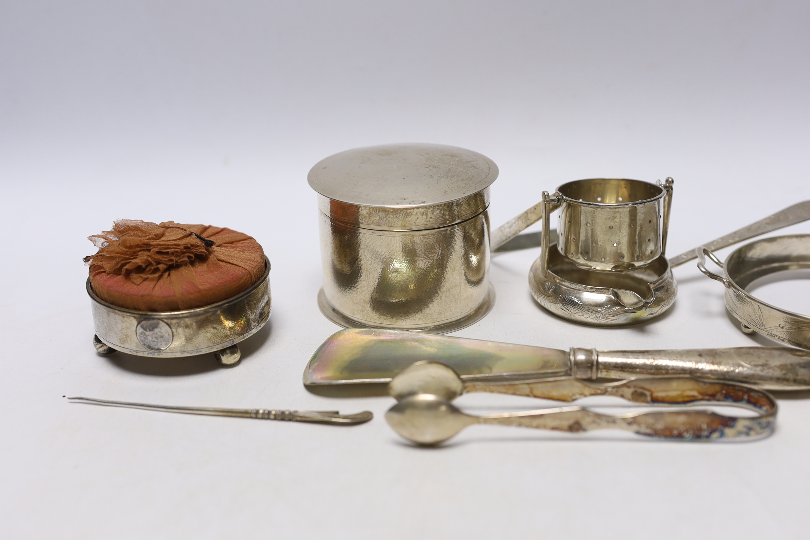 A group of assorted Chinese white metal items, including a box and cover by Lainchang, base by Zeesung, tea strainer napkin ring, etc and a mounted pin cushion by Tok Sang, 74mm.